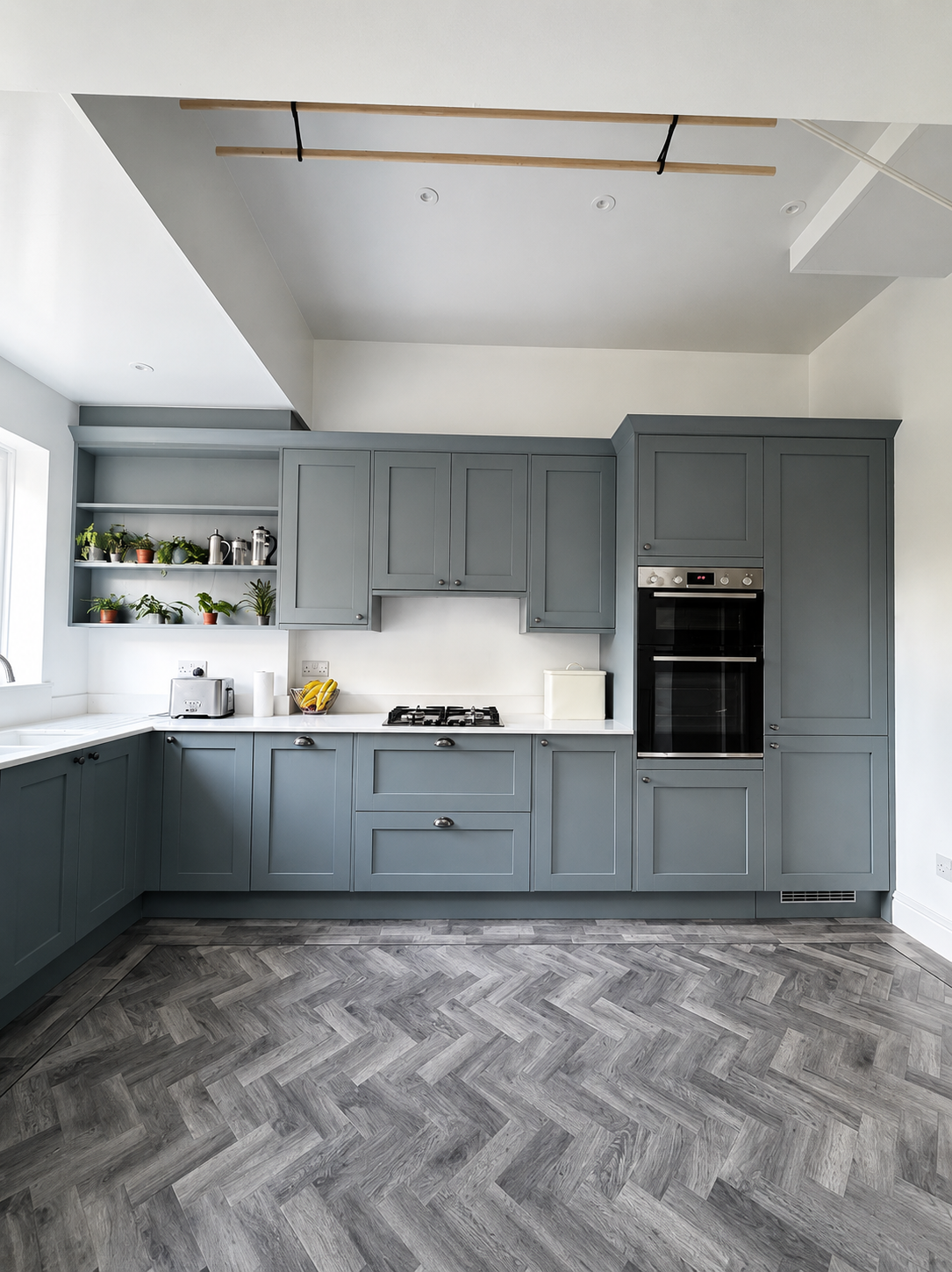 Blue-grey shaker kitchen with herringbone flooring fitted by C&B Joinery in Cumbria